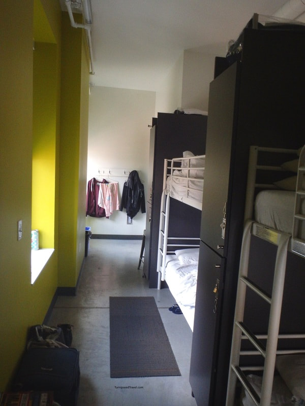 A four bed dorm room with grey and yellow walls