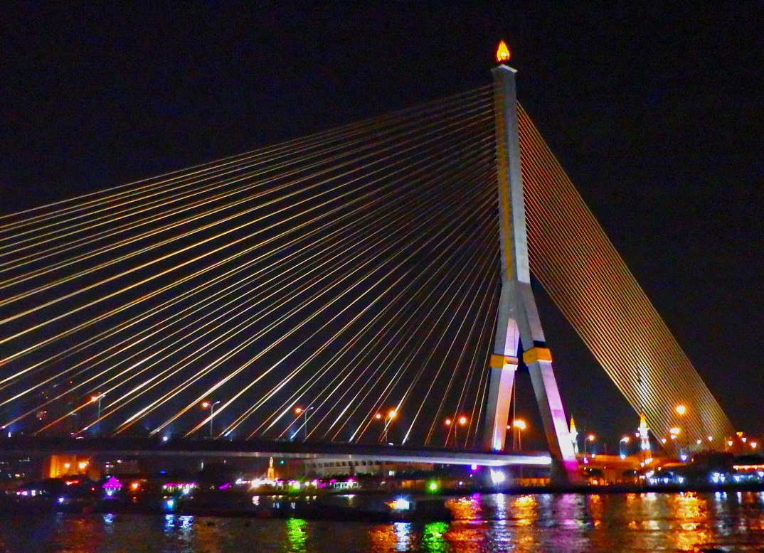 A dramatic bridge lit up at night