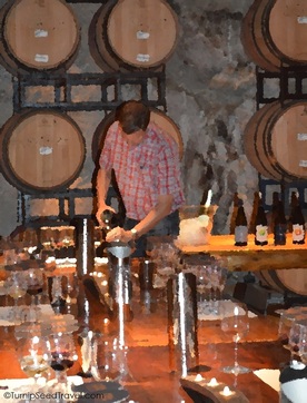 Henry of Pelham Estate pouring wine in the cellar TurnipSeedTravel.com
