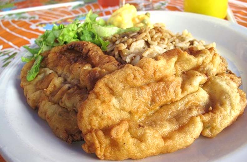 Fried fish on a white plate with a side of rice Picture