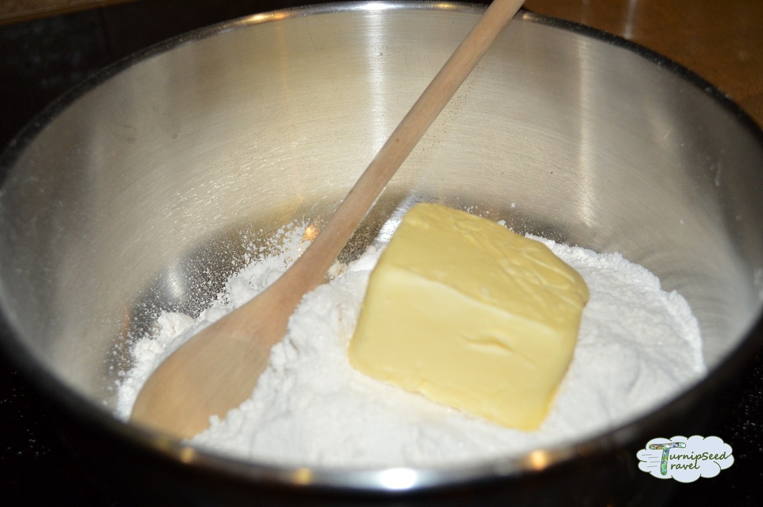Combining sugar, flour, and butter for the shortbread base.