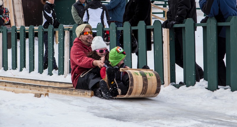 Father and two children on a toboggan 