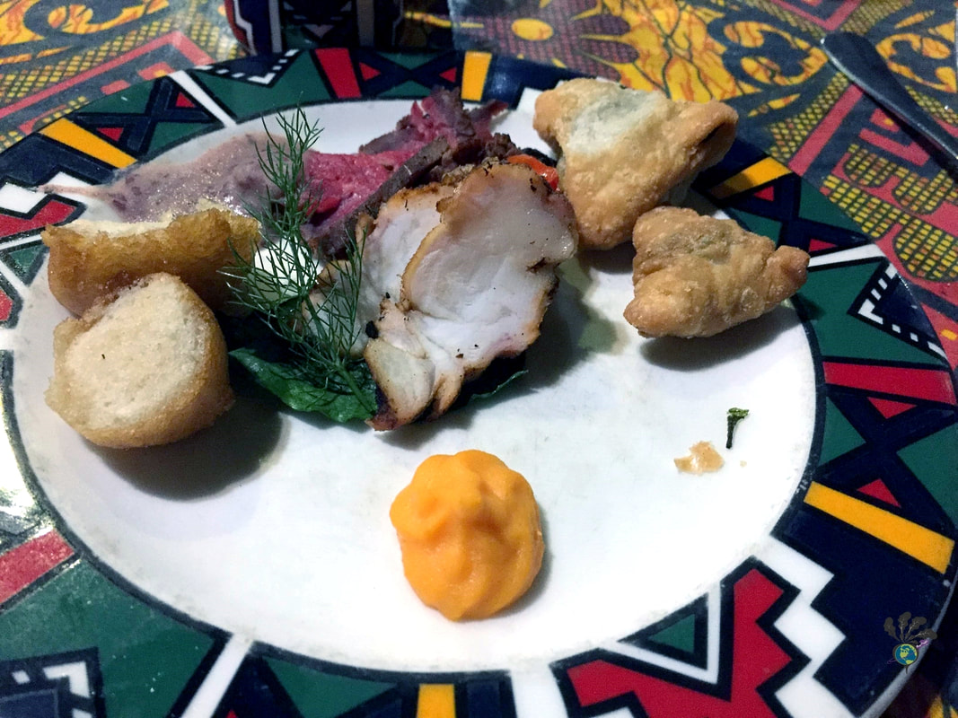 BOMA Victoria Falls buffet and drumming show Plate of assorted appetizers on a colorful tablecloth