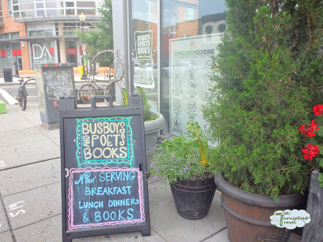 Busboys and Poets front door exterior with chalk sign and flower planters Picture