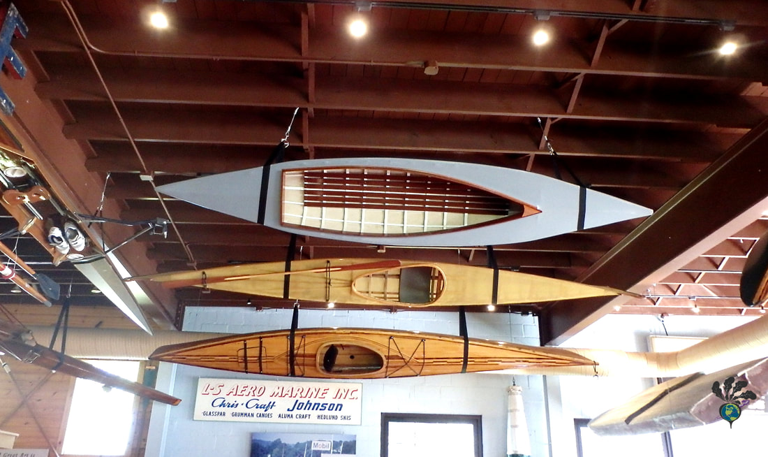 Wooden canoes and kayaks hang from the museum's ceilingPicture