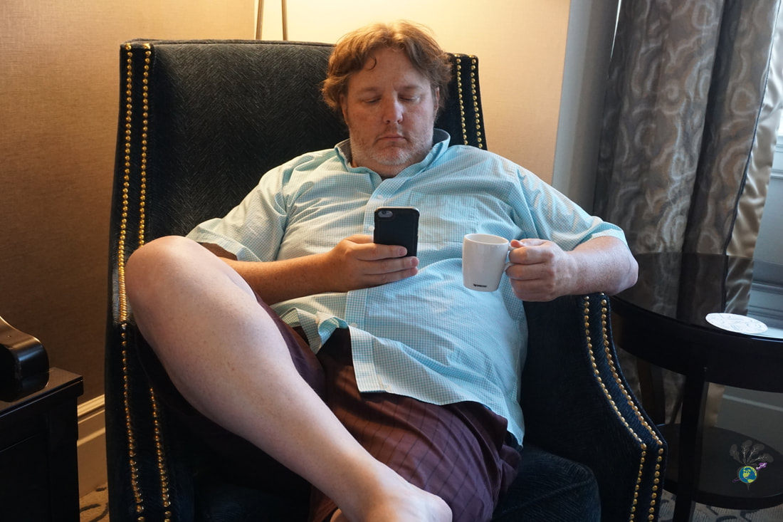 Ryan sips espresso while sitting in a black chair at Chateau Laurier Picture