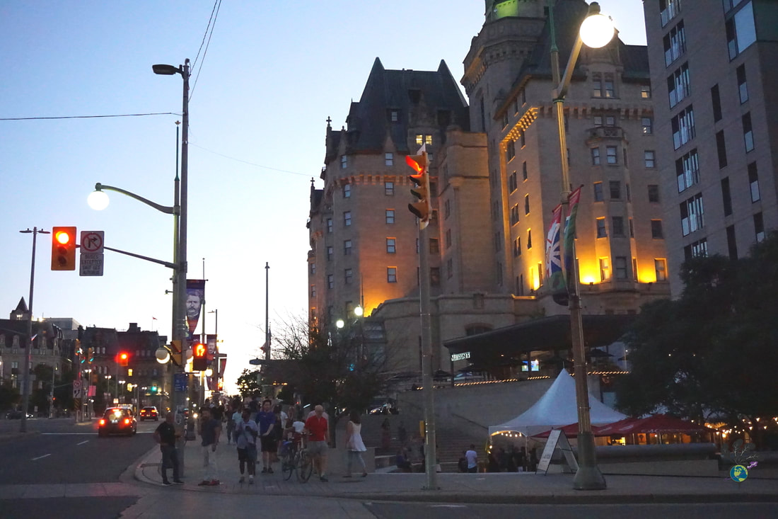 Outside the Chateau Laurier at dusk with people standing on the cornerPicture