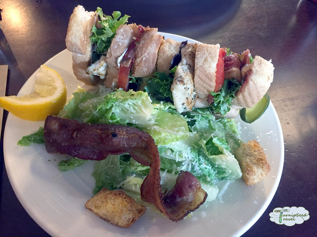 Club sandwich with a side of Caesar salad