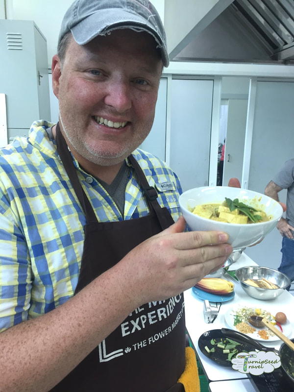 Posing with a bowl of chicken curry in coconut milk in our Bangkok cooking class