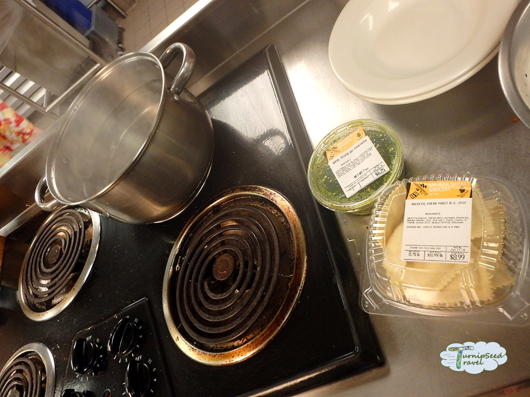 Boiling water to prep pasta in Hosteling International's kitchen Picture