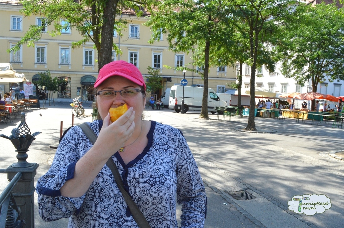 Vanessa eat a nectarine at the market Picture