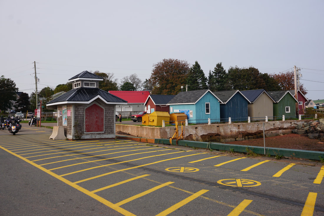 Colourful sheds as seen from the parking lot of the wharf Picture