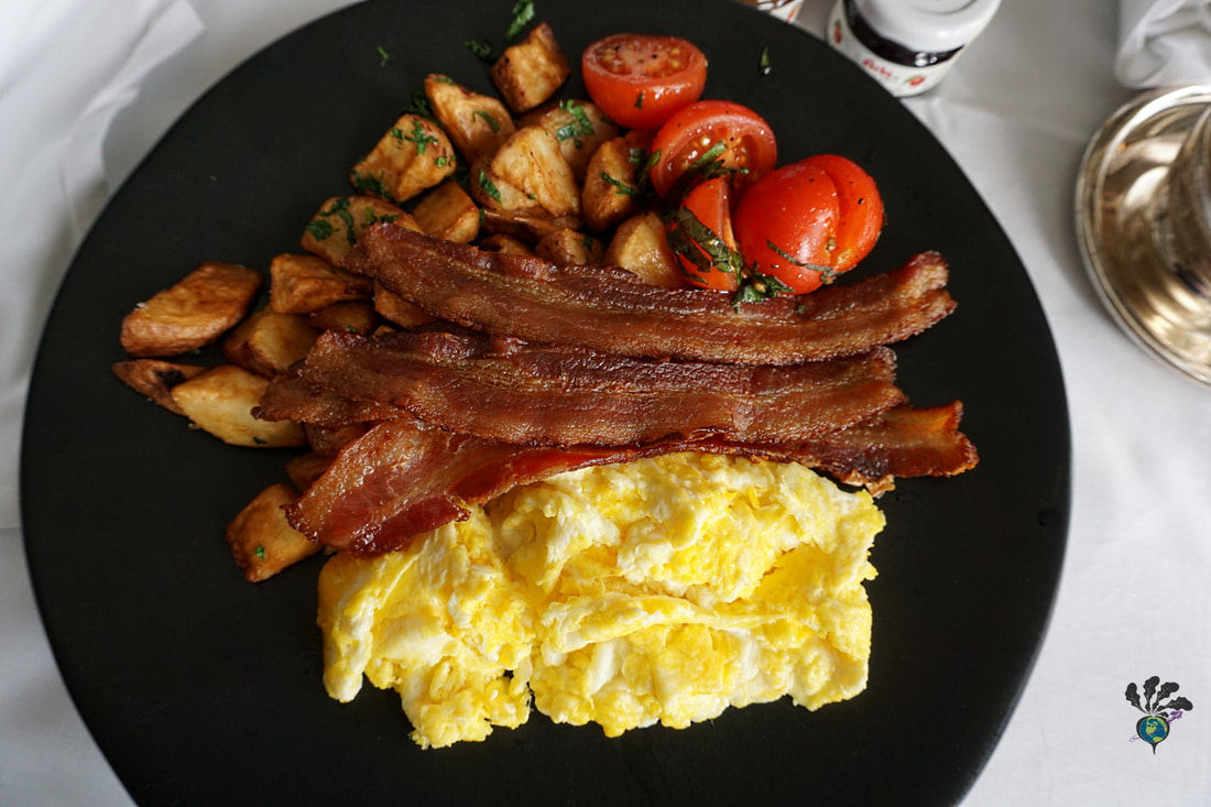 Vacation breakfast idea: Plate of bacon and eggs with hasbrowns and potatoes 