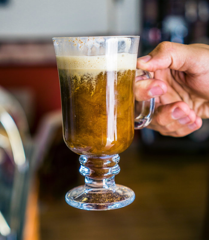 Clear mug of Irish coffee, with the cream melting into the hot liquid Picture