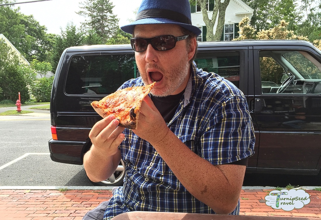 Ryan eats a slice of pizza outside Picture