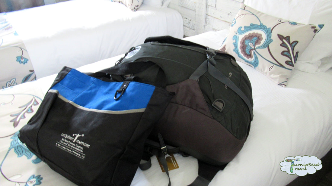 Grey backpack and blue and black tote bag to illustrate packing techniques Picture