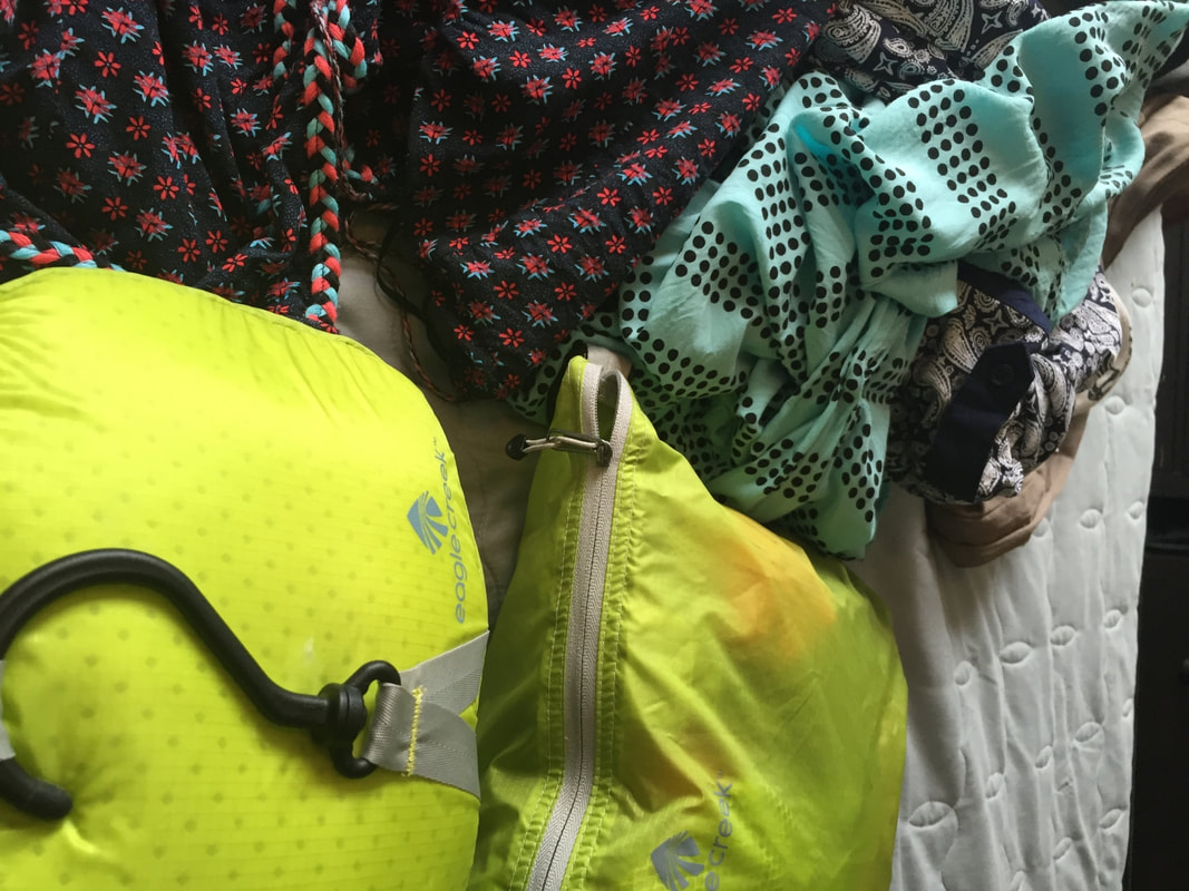 Travel clothing and yellow toiletry kit