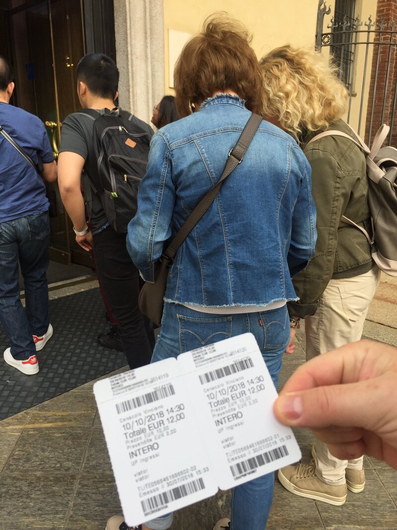 Holding ticket receipts in Milan.