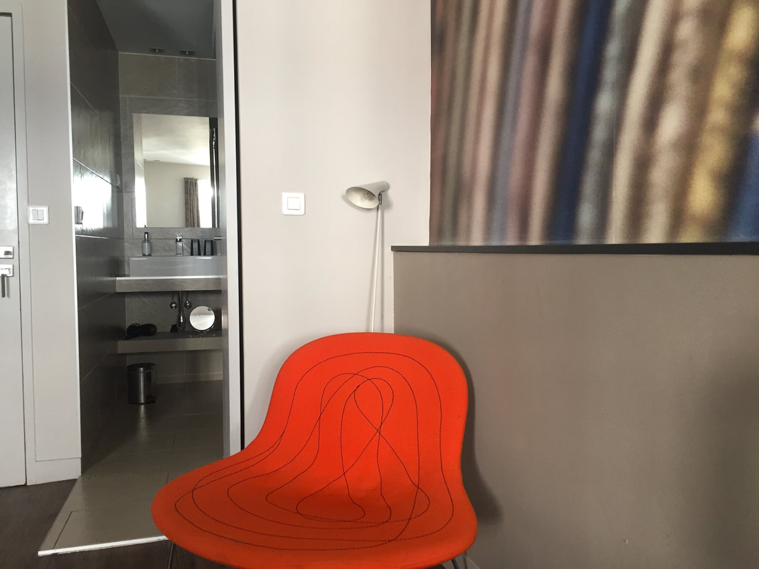 Bright orange modern chair in the hotel room