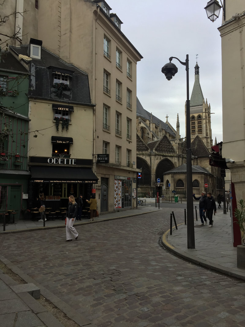 Medieval buildings, more modern buildings, and a church in central Paris.