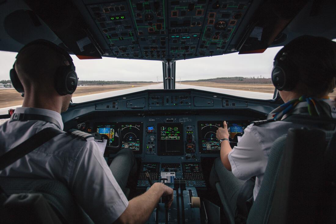 Canadian Transportation Agency Flight Delay Compensation Rules. Two pilots in the cockpit