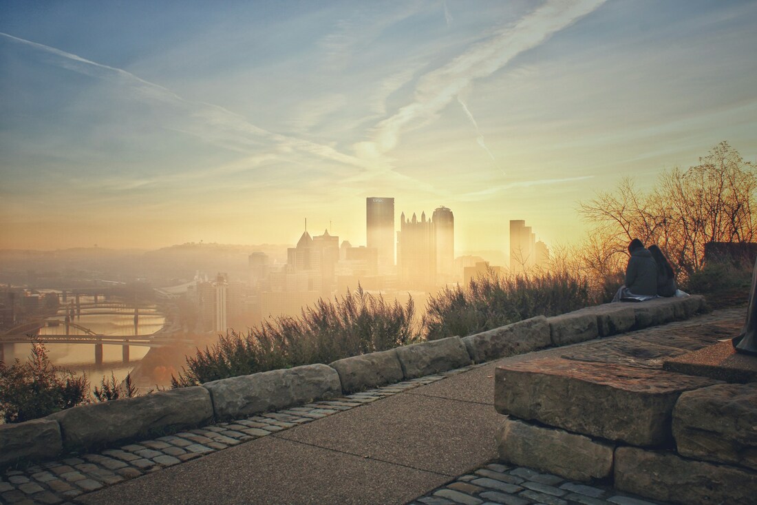 12 Things to do in Pittsburgh for couples: Pittsburgh city scape on a hazy dawn, as seen from a trail Picture