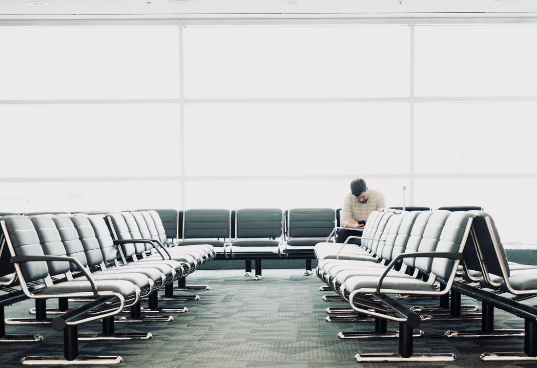 Canadian Transportation Agency Flight Delay Compensation Rules. Solo passenger sits alone in the airport surrounded by empty chairs