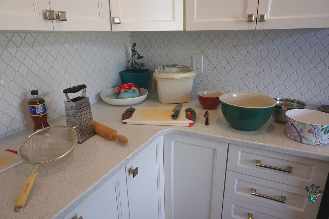 White kitchen counter set up with bowls and other cooking suppliesPicture