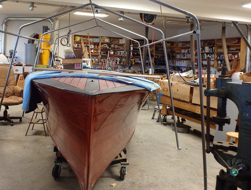 A boat undergoes restoration in the museum's workshop Picture