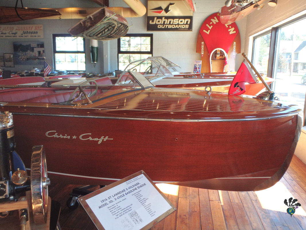 The front of a vintage motorboat surrounded by boating memorabilia Picture