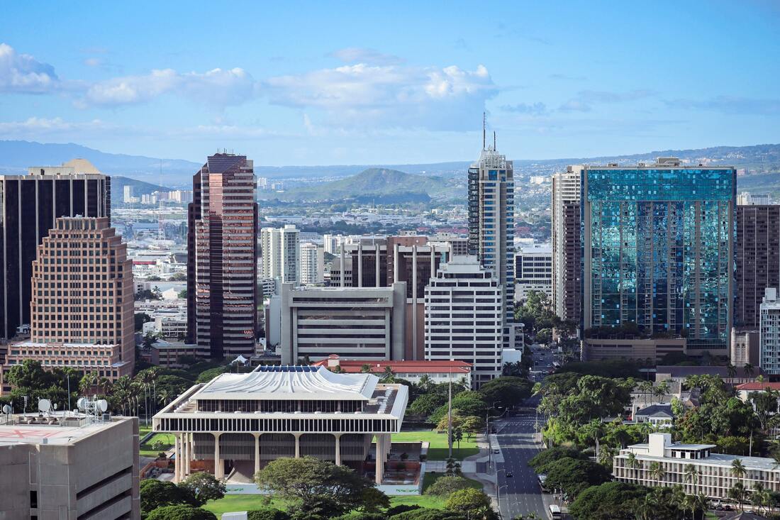 Downtown Honolulu with modern skyscrapers and diamond head volcano in the background