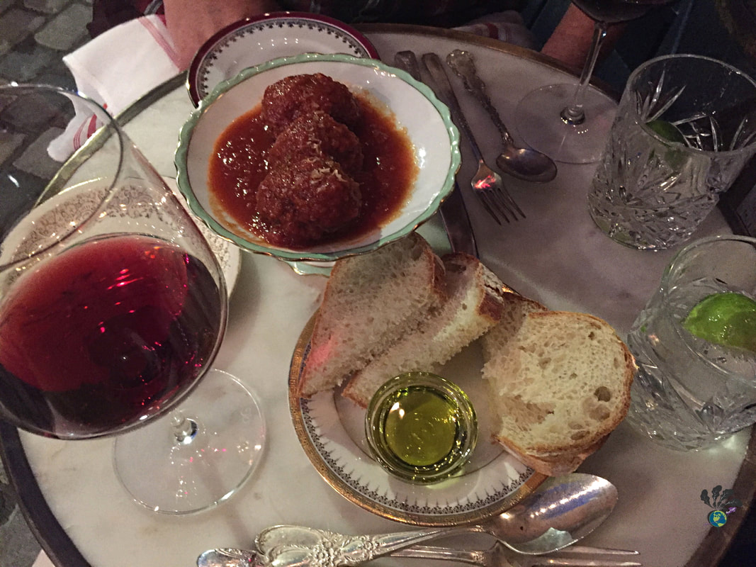 Ottawa staycation: A small table at North and Navy is covered with wine glasses, water glasses, and mismatched plates containing bread, olive oil, and meatballs with tomato sauce.