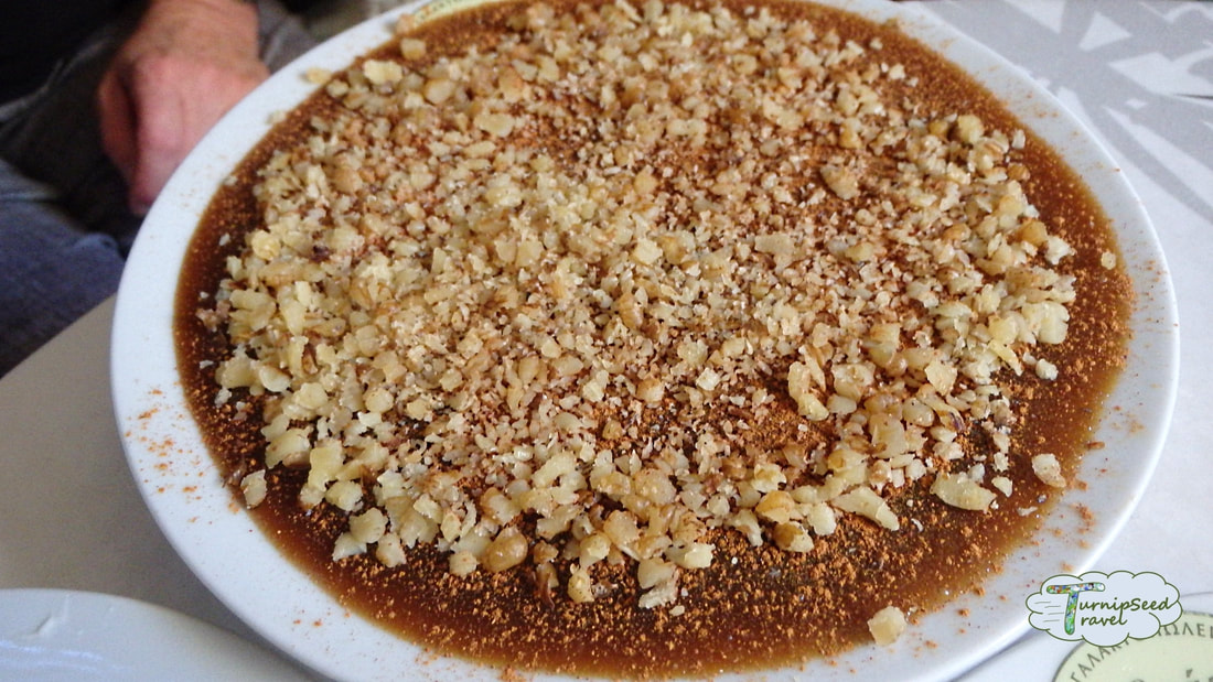 Wine pudding covered with nuts and cinnamon in Athens Picture