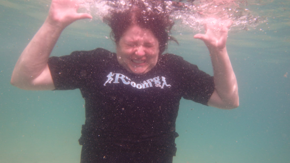 Vanessa swims underwater in a black Running Room shirt