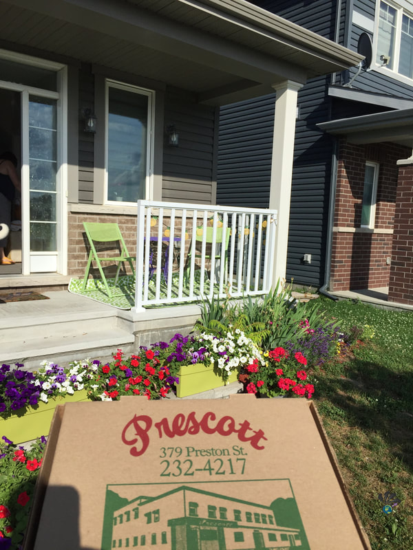 Bringing home a cardboard box of Prescott pizza 