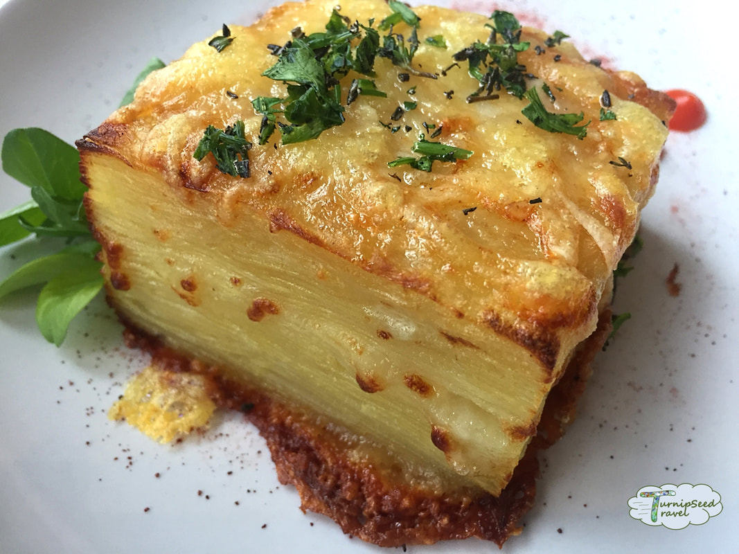 A cube of cheese and herb encrusted scalloped potatoes from Black Tartan Kitchen. 