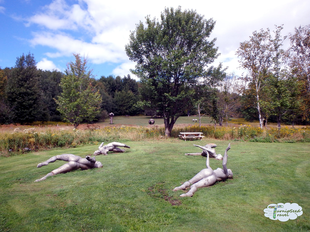 Griffis Sculpture Park Ellicottville NY Sculptures of people lying on the grass