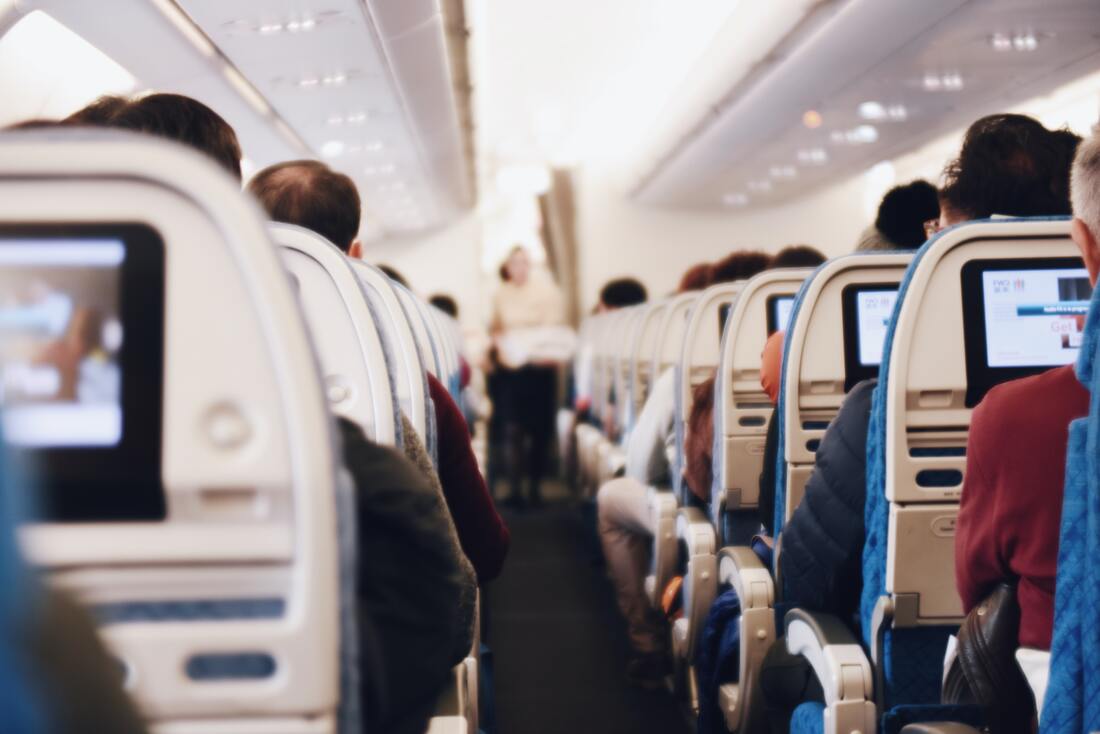Canadian Transportation Agency Flight Delay Compensation Rules. Passengers sit in economy class on an airplane