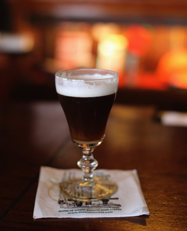Clear glass filled with Irish coffee, set upon a napkin Picture