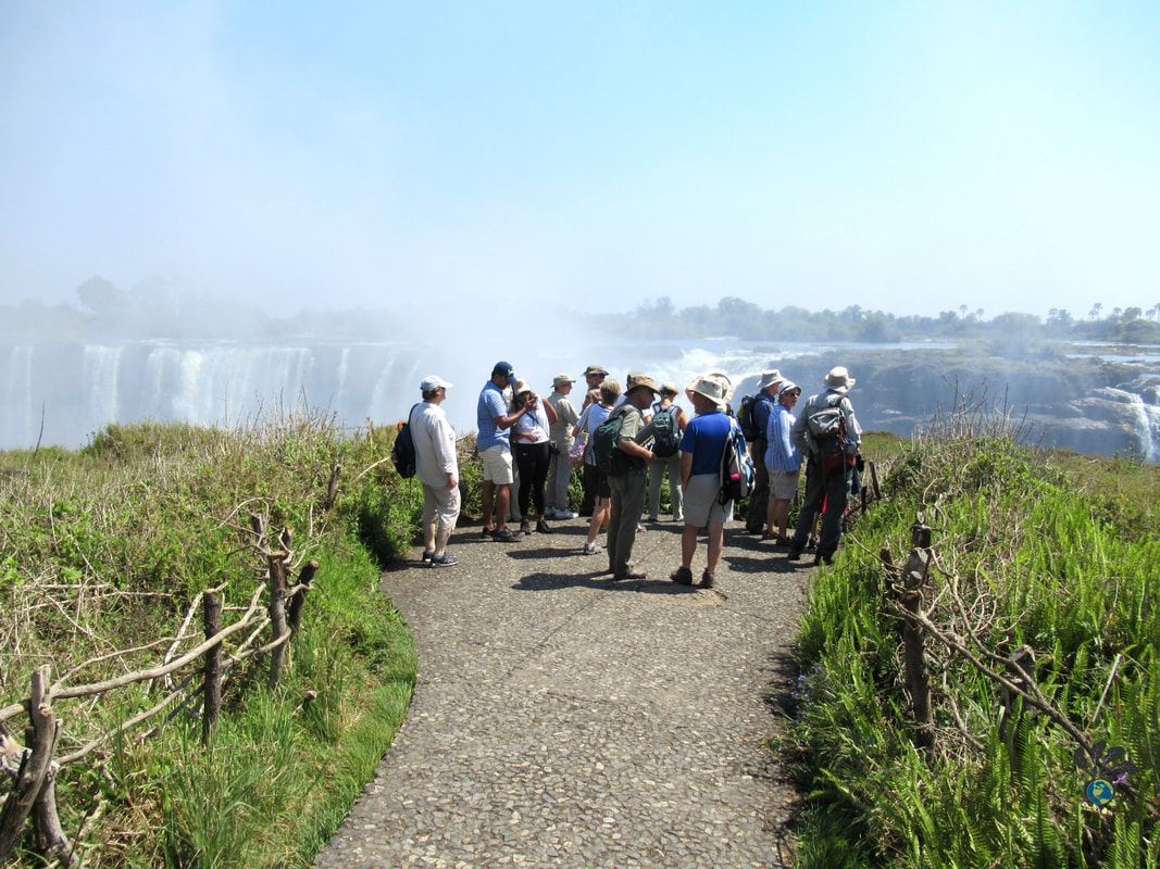 Tour group gathered at a look out in Victoria Falls National Park to see the waterfalls