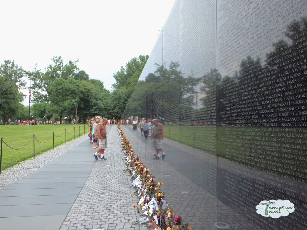 Flowers at the base of the Vietnam Veterans Memorial Wall in Washington DC Picture