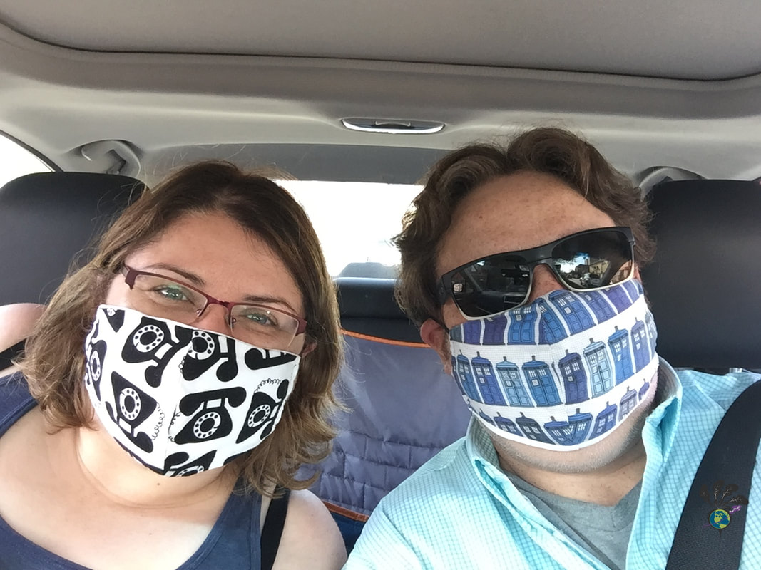 Ryan and Vanessa wear fabric face masks in a selfie.