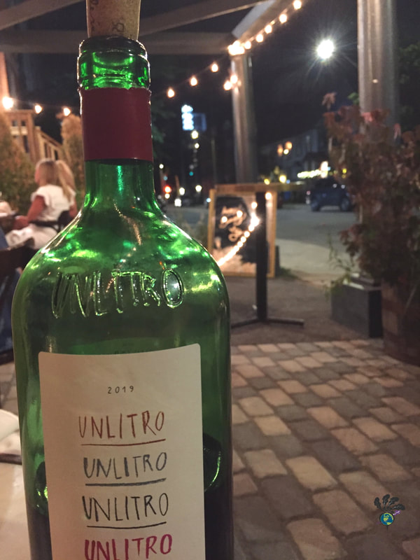 Green bottle of wine on the North and Navy patio